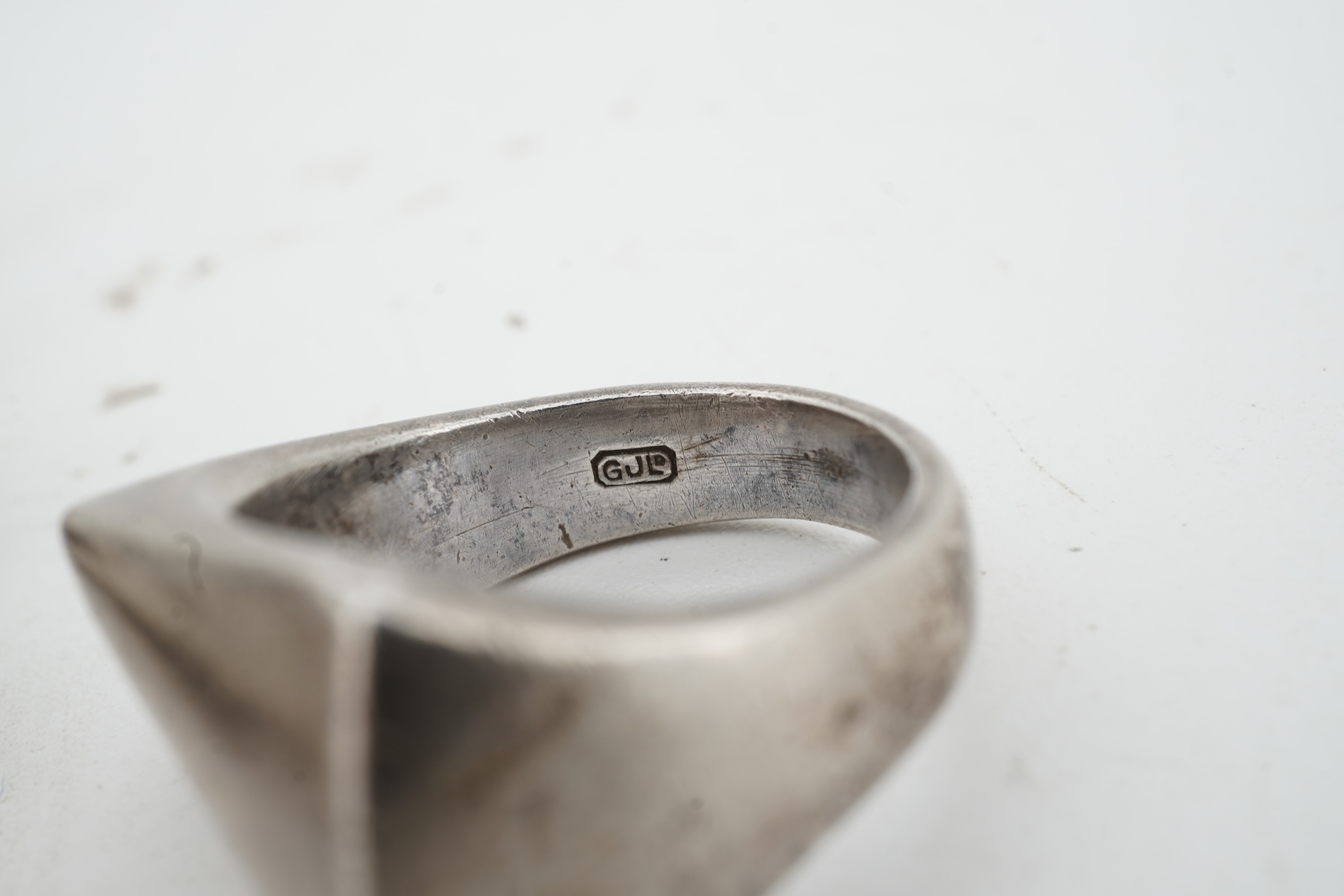 Nanna Ditzel for Georg Jensen, a silver bracelet, circa 1972, and a Georg Jensen ring, circa 1968, the bracelet composed of polished oval links with a concealed hoop clasp, length approximately 17cm, signed Georg Jensen,